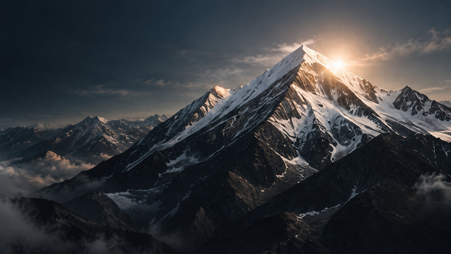 Snow-capped mountain peak catching the sun above the clouds